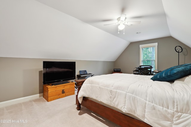 carpeted bedroom with vaulted ceiling, a ceiling fan, and baseboards