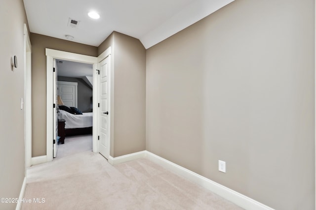 hall featuring carpet and baseboards