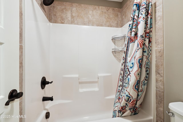 bathroom with shower / bath combo with shower curtain and toilet
