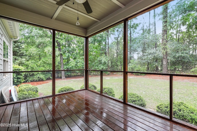 unfurnished sunroom with a ceiling fan and plenty of natural light