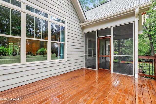 wooden deck with a sunroom