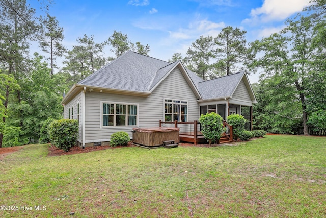 back of property featuring a hot tub, a sunroom, a shingled roof, a yard, and a deck