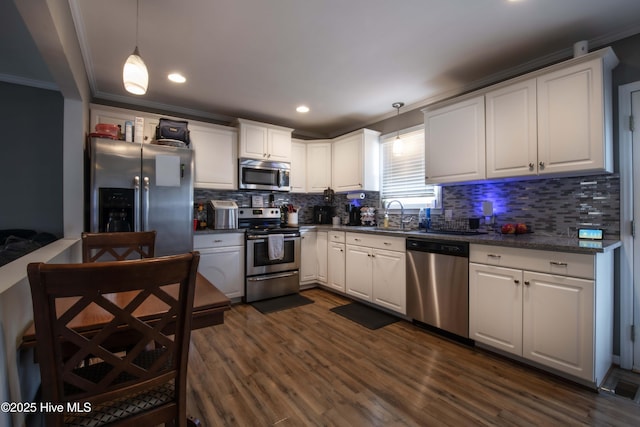 2518 Pilot-Riley Rd, Zebulon, NC 27597 - kitchen with appliances with stainless steel finishes, ornamental molding, white cabinetry, dark countertops, and recessed lighting