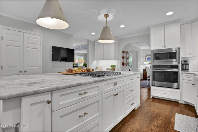 1218 Country Club Rd, Wilmington, NC 28403 - kitchen featuring appliances with stainless steel finishes, arched walkways, ornamental molding, decorative backsplash, and recessed lighting