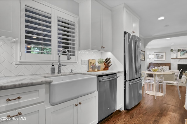 1218 Country Club Rd, Wilmington, NC 28403 - kitchen with stainless steel appliances, a sink, dark wood-type flooring, tasteful backsplash, and crown molding