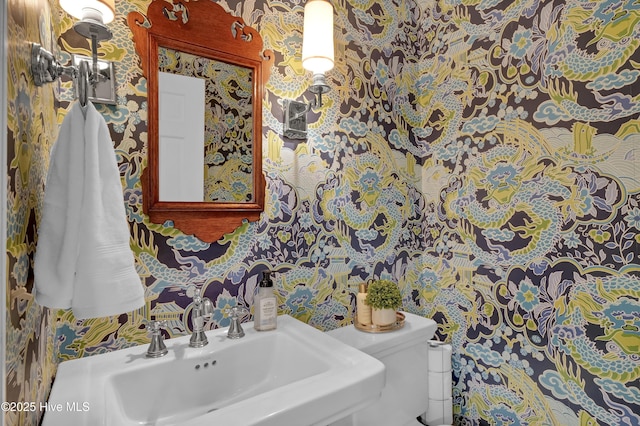 1218 Country Club Rd, Wilmington, NC 28403 - half bathroom featuring wallpapered walls, toilet, and a sink