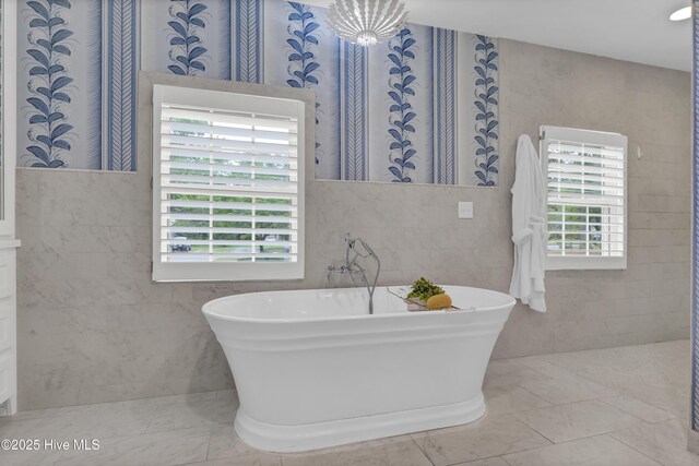 1218 Country Club Rd, Wilmington, NC 28403 - full bathroom with tile walls, healthy amount of natural light, and a freestanding bath