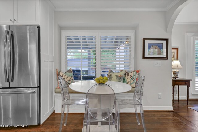 1218 Country Club Rd, Wilmington, NC 28403 - dining area with dark wood-style floors, plenty of natural light, arched walkways, ornamental molding, and baseboards