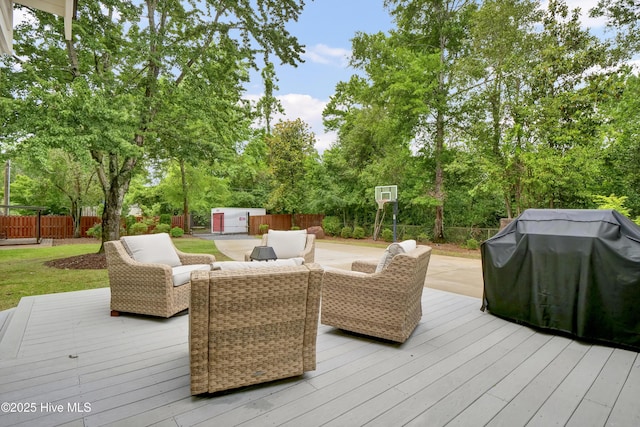 1218 Country Club Rd, Wilmington, NC 28403 - wooden terrace with a storage shed, a fenced backyard, an outdoor structure, area for grilling, and view of wooded area