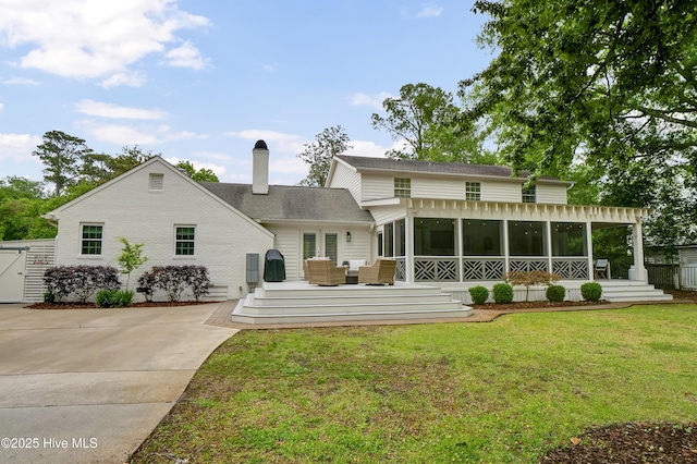 1218 Country Club Rd, Wilmington, NC 28403 - rear view of house featuring a sunroom, a chimney, a deck, an outdoor hangout area, and driveway