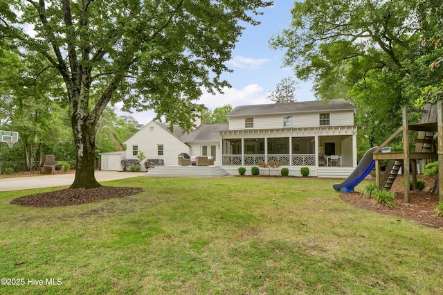 1218 Country Club Rd, Wilmington, NC 28403 - rear view of property with a sunroom, a playground, and a lawn