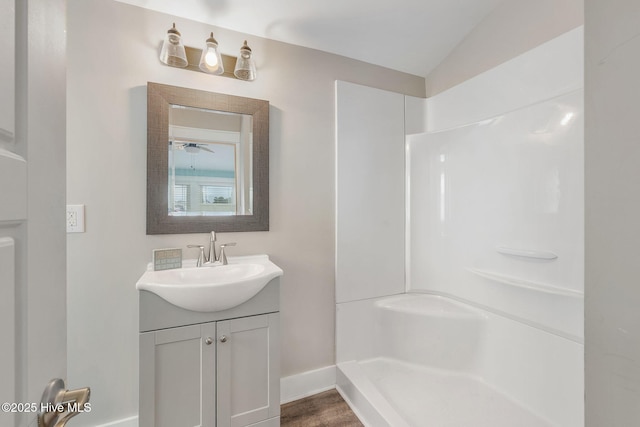 full bathroom with vanity, baseboards, and a shower