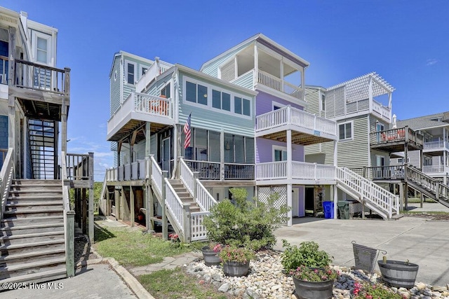 rear view of property featuring stairs