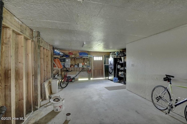 167 Topsail Rd, North Topsail Beach, NC 28460 - below grade area with a textured ceiling and freestanding refrigerator