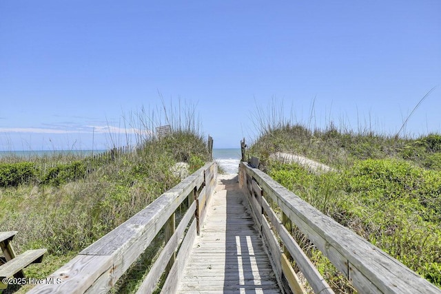 view of home's community featuring view of water and beach