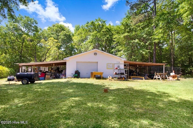 342 Shirley Plantation Dr, Snow Hill, NC 28580 - back of house featuring a detached garage, a yard, an outbuilding, and view of scattered trees