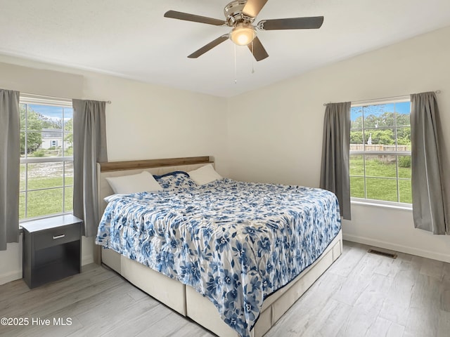70 Little Pond Rd, Rocky Point, NC 28457 - bedroom with multiple windows, light wood-style flooring, baseboards, and ceiling fan