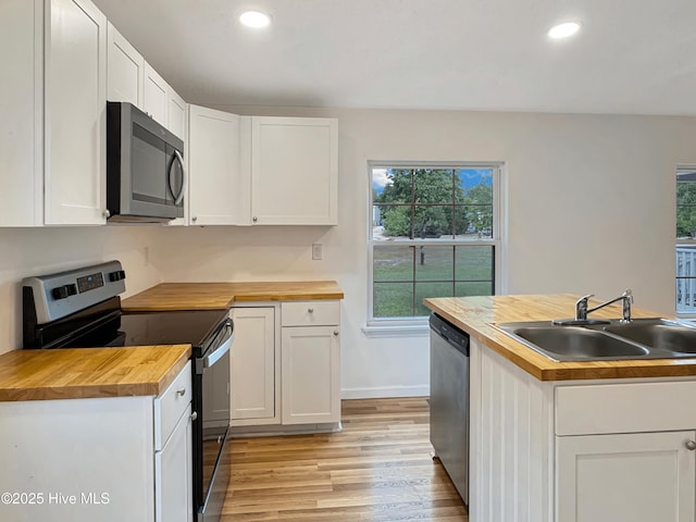 70 Little Pond Rd, Rocky Point, NC 28457 - kitchen featuring butcher block counters, appliances with stainless steel finishes, a sink, light wood-type flooring, and recessed lighting