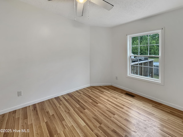70 Little Pond Rd, Rocky Point, NC 28457 - empty room with a textured ceiling, baseboards, light wood-type flooring, and ceiling fan