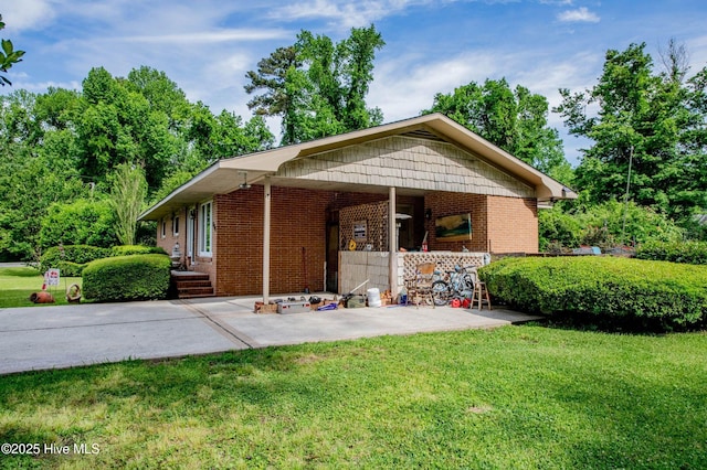 525 Edwards Rd, Jacksonville, NC 28540 - view of front of home with a front lawn, brick siding, and a patio