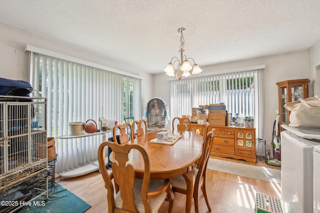 525 Edwards Rd, Jacksonville, NC 28540 - dining area featuring light wood-style flooring, a chandelier, and a textured ceiling