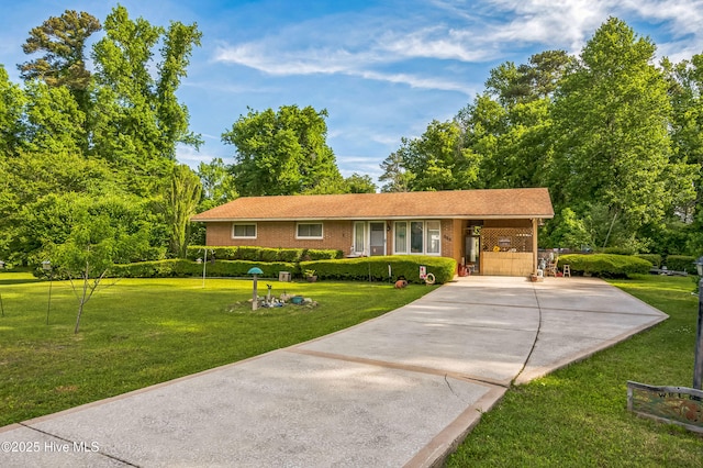 525 Edwards Rd, Jacksonville, NC 28540 - ranch-style home featuring concrete driveway, a front lawn, and brick siding