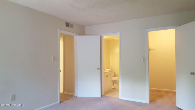 500 Umstead Dr Unit 304C, Chapel Hill, NC 27516 - unfurnished bedroom with a walk in closet and light carpet