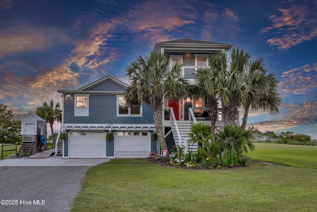 1855 Newkirk Rd, Wilmington, NC 28409 - coastal home featuring stairway, a yard, an attached garage, and asphalt driveway