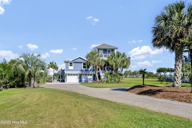 1855 Newkirk Rd, Wilmington, NC 28409 - coastal home featuring stairway, a garage, a front yard, and driveway