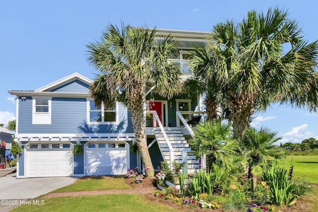 1855 Newkirk Rd, Wilmington, NC 28409 - coastal home featuring stairs, a garage, and concrete driveway