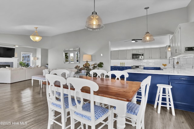 1855 Newkirk Rd, Wilmington, NC 28409 - dining room featuring wood finished floors, ceiling fan, and a fireplace