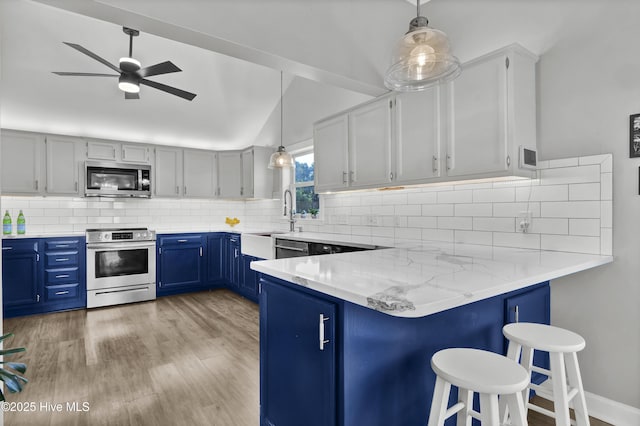 1855 Newkirk Rd, Wilmington, NC 28409 - kitchen featuring stainless steel appliances, blue cabinetry, a sink, a peninsula, and a ceiling fan