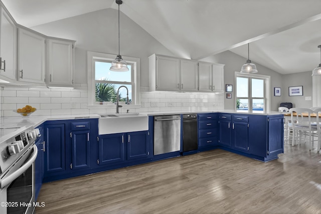 1855 Newkirk Rd, Wilmington, NC 28409 - kitchen with stainless steel appliances, lofted ceiling, a sink, a peninsula, and blue cabinets