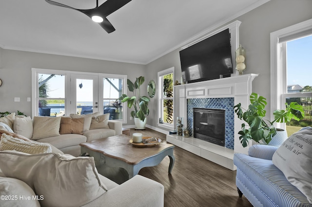 1855 Newkirk Rd, Wilmington, NC 28409 - living room featuring a ceiling fan, ornamental molding, dark wood-type flooring, a fireplace, and baseboards