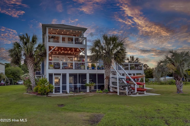 1855 Newkirk Rd, Wilmington, NC 28409 - back of property with a balcony, a yard, and a sunroom