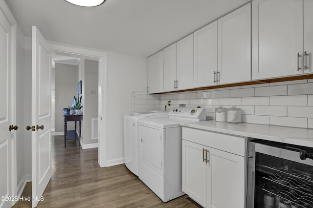 1855 Newkirk Rd, Wilmington, NC 28409 - laundry area with wine cooler, independent washer and dryer, light wood-type flooring, baseboards, and cabinet space