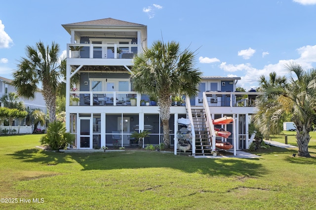1855 Newkirk Rd, Wilmington, NC 28409 - back of property with a balcony, a sunroom, a yard, and stairs