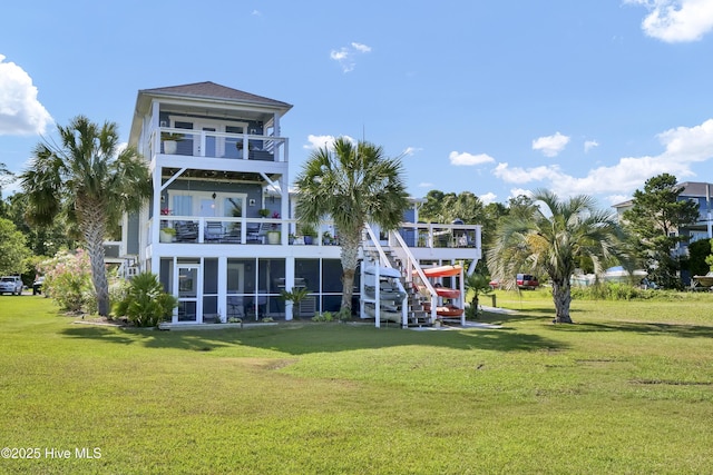 1855 Newkirk Rd, Wilmington, NC 28409 - rear view of house with a balcony, a yard, and a sunroom