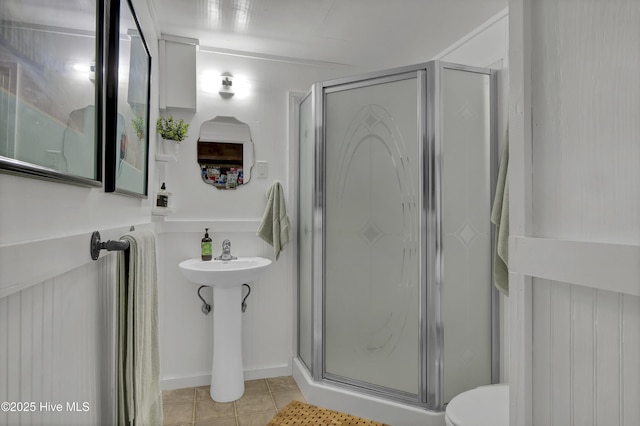 1855 Newkirk Rd, Wilmington, NC 28409 - full bath featuring a stall shower, toilet, tile patterned floors, and a sink