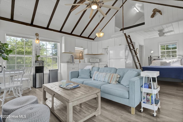 1855 Newkirk Rd, Wilmington, NC 28409 - living room featuring ceiling fan, light wood-style floors, high vaulted ceiling, and beamed ceiling