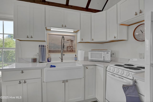 1855 Newkirk Rd, Wilmington, NC 28409 - kitchen featuring white appliances, light countertops, white cabinets, and a sink