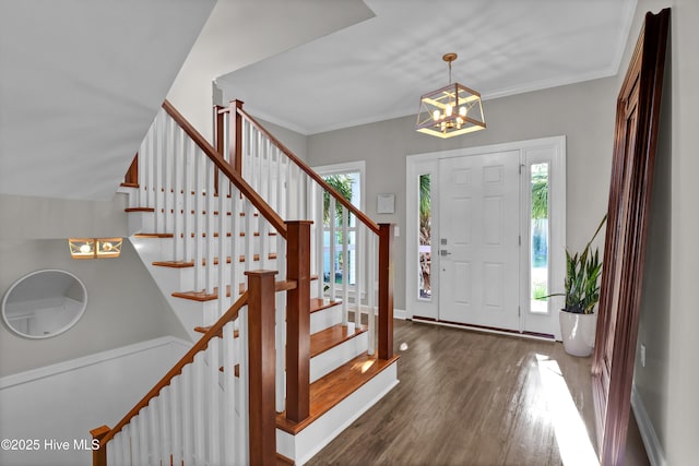 1855 Newkirk Rd, Wilmington, NC 28409 - entryway featuring plenty of natural light, stairway, wood finished floors, a chandelier, and ornamental molding
