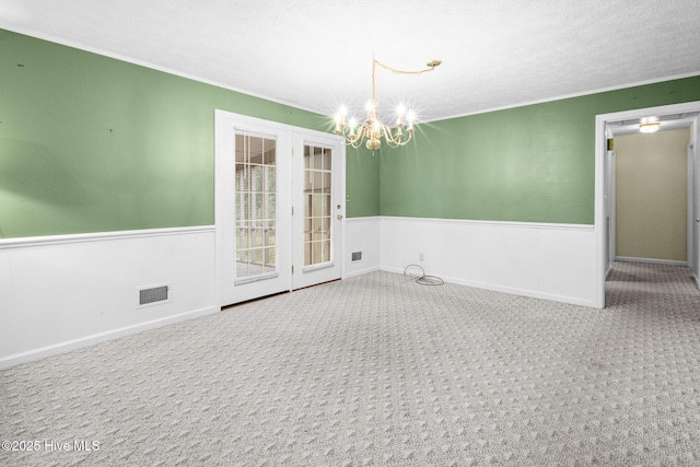 330 Breckenridge Dr, Wilmington, NC 28412 - carpeted empty room with a chandelier, a wainscoted wall, and crown molding