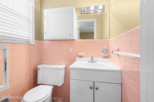 330 Breckenridge Dr, Wilmington, NC 28412 - half bathroom featuring tile walls, toilet, vanity, and a wainscoted wall