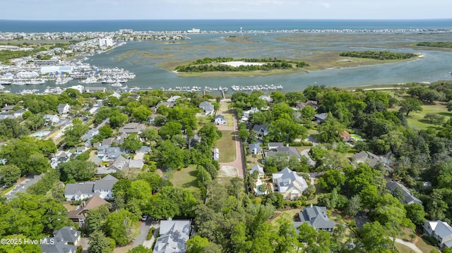 aerial view of property's location with a nearby body of water and nearby suburban area
