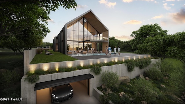 rear view of property with a balcony, a yard, a patio area, and an outdoor hangout area