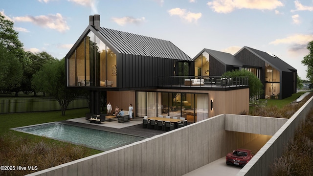 back of house with a balcony and outdoor lounge area