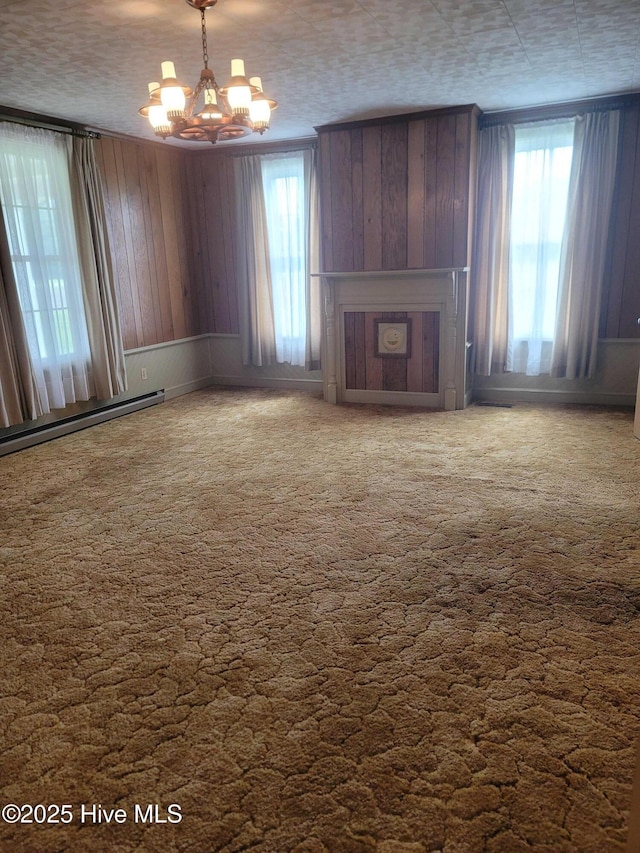146 Gliden Rd, Hobbsville, NC 27946 - unfurnished living room with a chandelier, carpet floors, a baseboard heating unit, and a fireplace