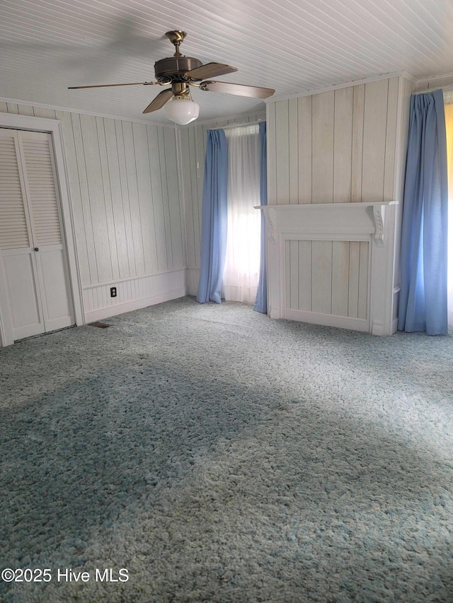 146 Gliden Rd, Hobbsville, NC 27946 - carpeted spare room with a ceiling fan and wooden walls