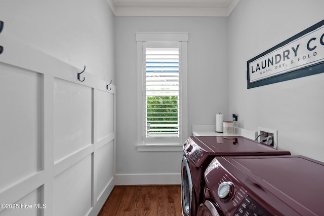 clothes washing area featuring washer and dryer, ornamental molding, cabinet space, dark wood-style flooring, and baseboards